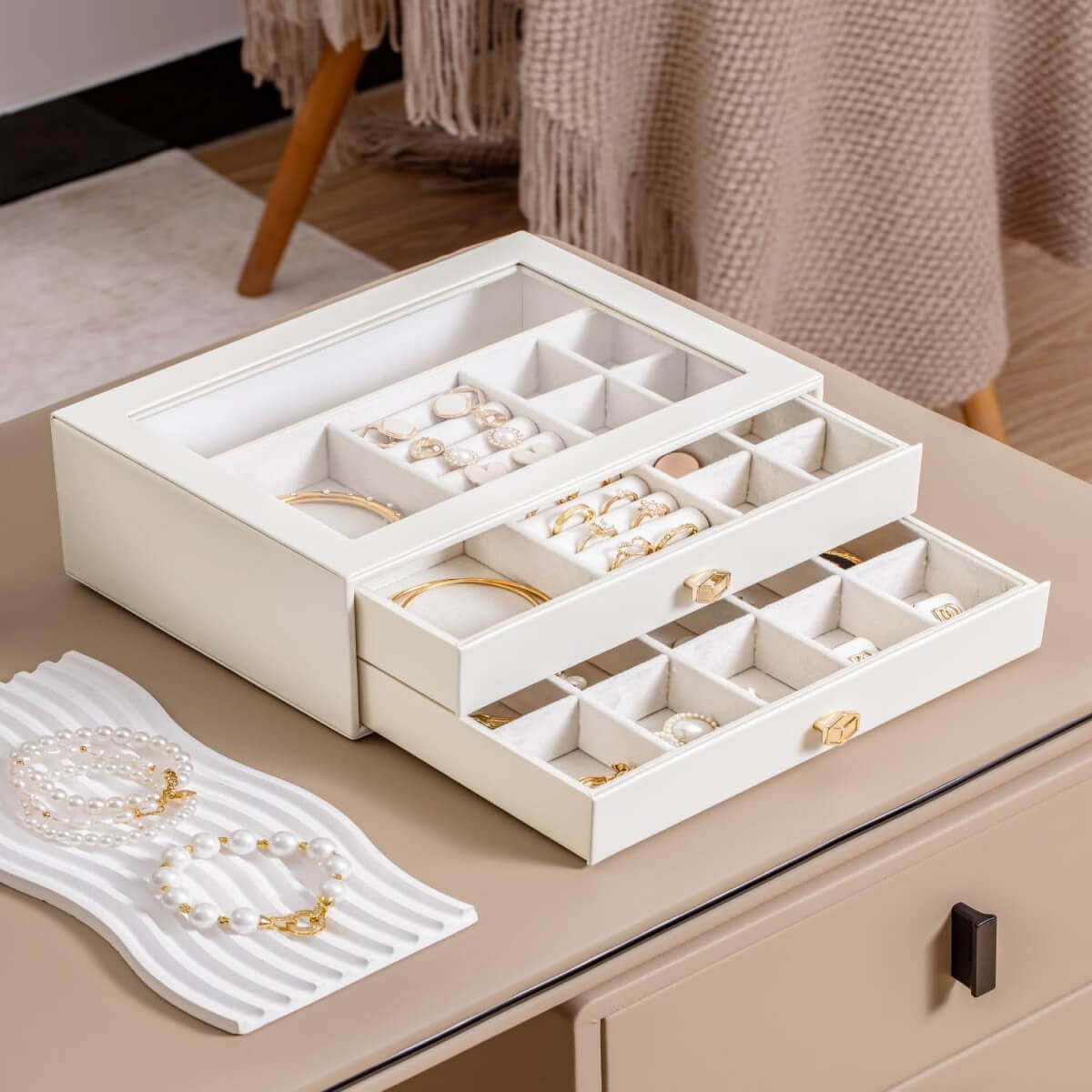 White multi-layer jewelry box with organized compartments on dresser