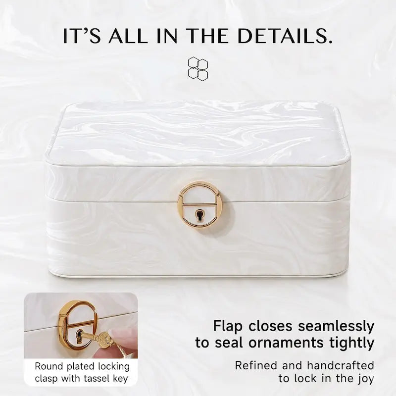 White 2-layer lockable jewelry box with round gold plated locking clasp and tassel key, closed front view