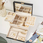 3-layer jewelry box open showing mirror lid, foldable top tray, adjustable ring and earring compartments and bottom drawer