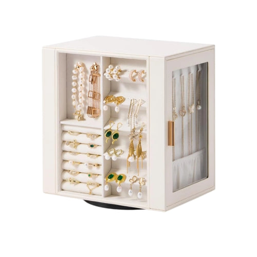 Cream white rotating leather jewelry case showcasing detailed interior filled with earrings and rings.