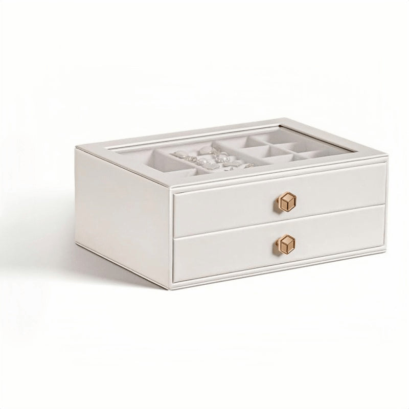 White 2-layer stackable jewelry box with glass lid and gold geometric knobs, being lifted