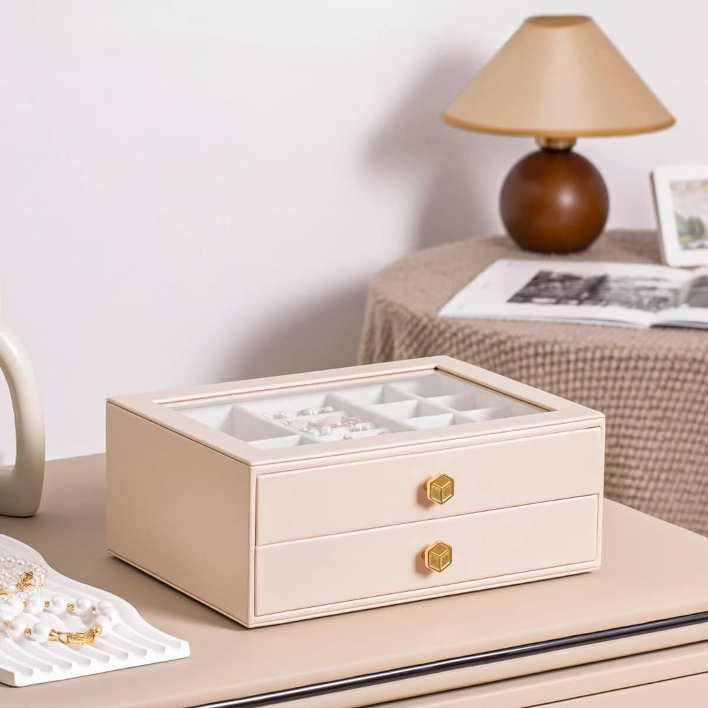 Pink glass lid jewelry box open on dresser in bedroom, lifestyle scene