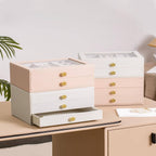 Pink and white glass lid jewelry boxes in mix-and-match stacked configurations on dresser