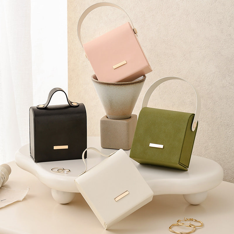 Handbag-style travel jewelry box in 4 colors, closed front view