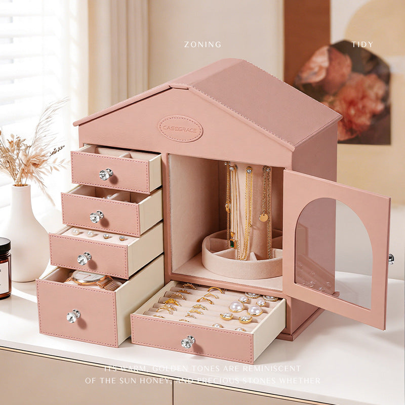 Pink house jewelry box open on dresser, lifestyle scene