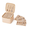 Pink mini travel jewelry box open with 6 zipper pockets laid out flat