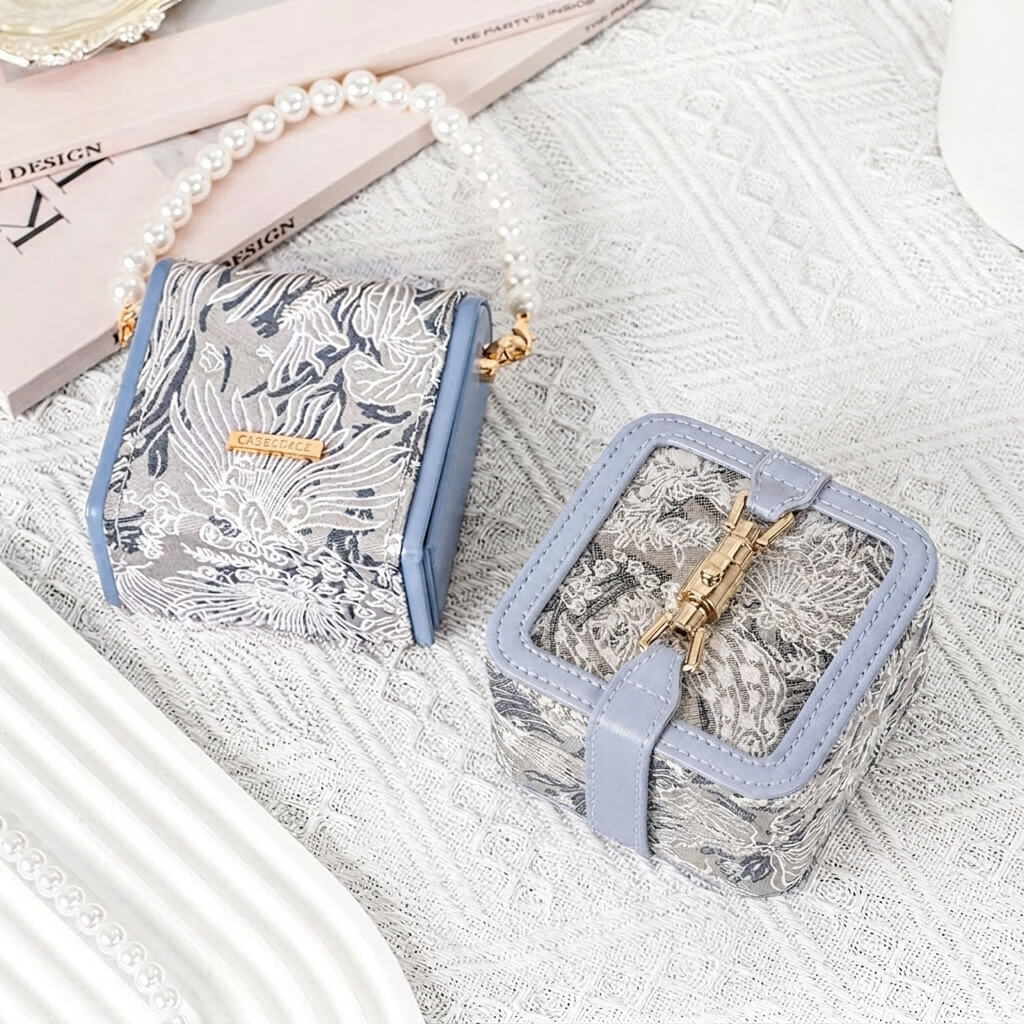 Pearl handle jewelry box and mini lock clasp jewelry box displayed together, both in 3D embroidered jacquard fabric